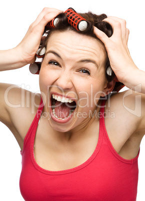 Woman is screaming holding her head with hands