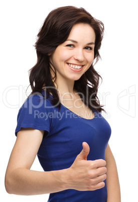 Woman is showing thumb up gesture