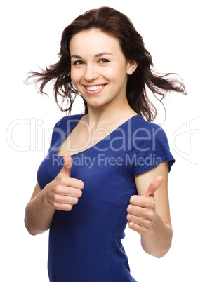 Woman is showing thumb up gesture