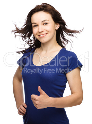 Woman is showing thumb up gesture