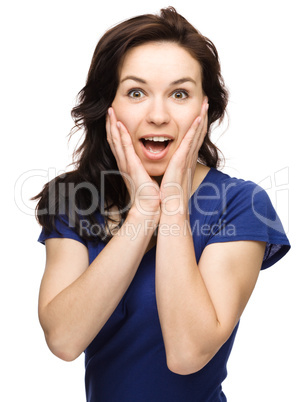 Woman is holding her face in astonishment