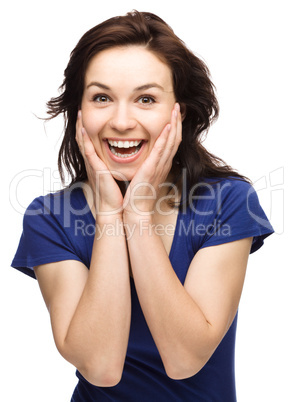 Woman is holding her face in astonishment