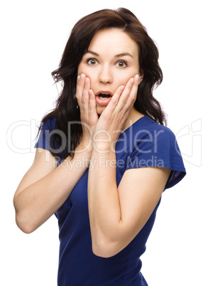 Woman is holding her face in astonishment