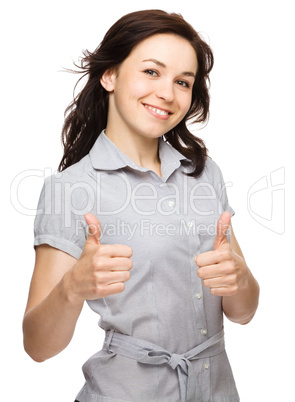 Woman is showing thumb up gesture