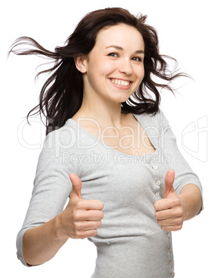 Woman is showing thumb up gesture