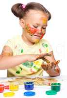 Portrait of a cute girl playing with paints