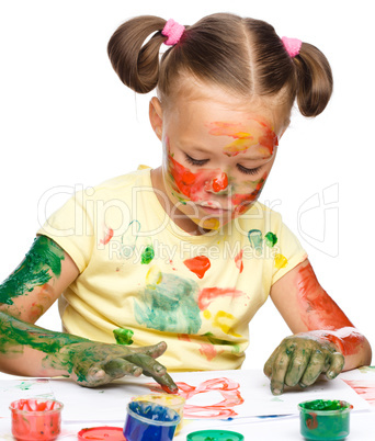 Portrait of a cute girl playing with paints