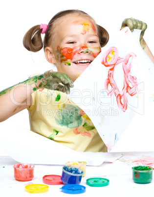 Portrait of a cute girl playing with paints