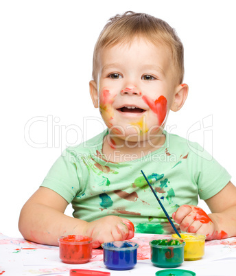 Little boy is playing with paints Little boy is playing with paints