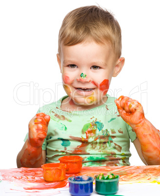 Little boy is playing with paints Little boy is playing with paints