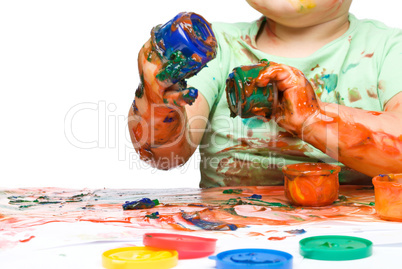 Child is grabbing some paint using fingers