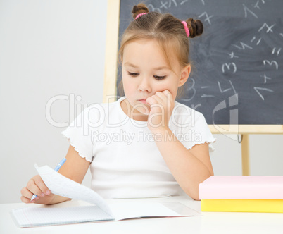 Little girl is studying