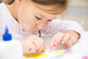 Little girl doing arts and crafts in preschool