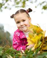 Portrait of a little girl in autumn park