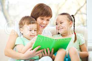 Mother is reading book for her children