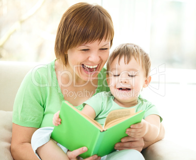 Mother is reading book for her son