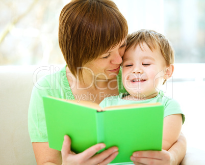 Mother is reading book for her son