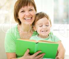 Mother is reading book for her son
