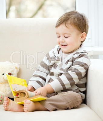 Little boy is reading book