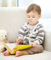 Little boy is reading book
