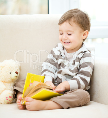 Little boy is reading book