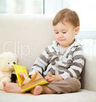 Little boy is reading book