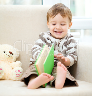 Little boy is reading book