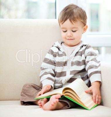 Little boy is reading book