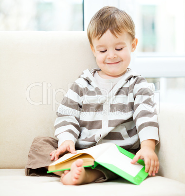 Little boy is reading book