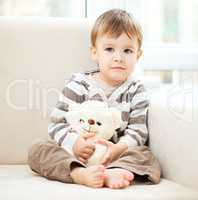 Portrait of a little boy with his teddy bear