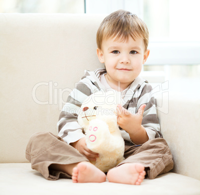 Portrait of a little boy with his teddy bear