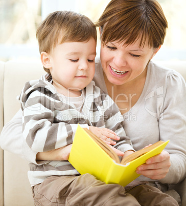 Mother is reading book for her son