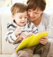 Mother is reading book for her son