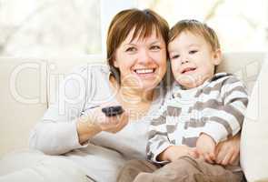 Mother and her son are watching tv