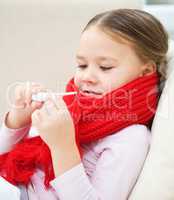 Ill little girl is reading thermometer