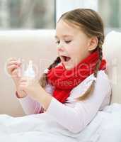 Little girl spraying her nose