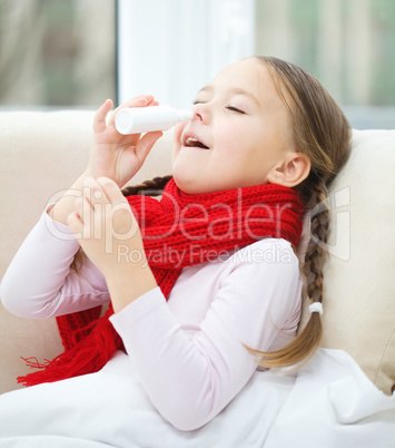 Little girl spraying her nose