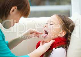 Doctor is examining little girl