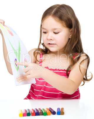 Little girl is showing her drawing