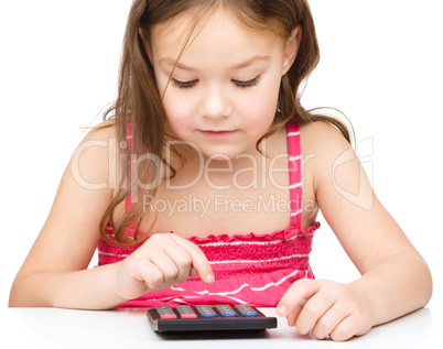 Little girl is using calculator