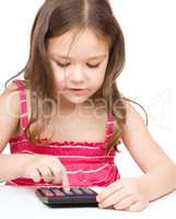 Little girl is using calculator