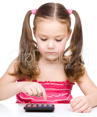 Little girl is using calculator