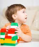 Boy is playing with building blocks