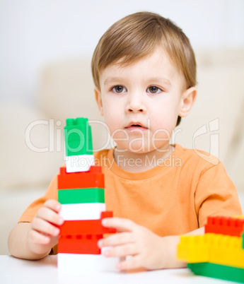 Boy is playing with building blocks