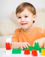 Boy is playing with building blocks