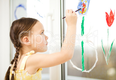 Portrait of a cute girl playing with paints