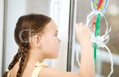 Portrait of a cute girl playing with paints