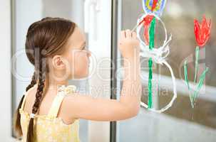 Portrait of a cute girl playing with paints