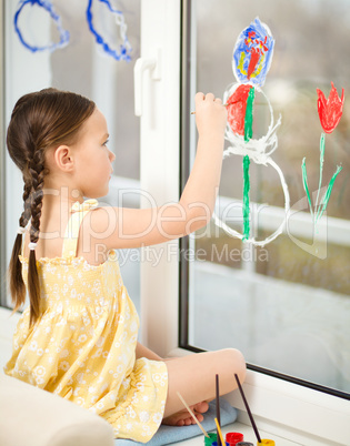 Portrait of a cute girl playing with paints