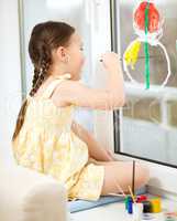 Portrait of a cute girl playing with paints